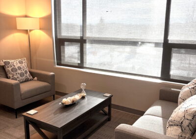 Bright and welcoming therapy room at Journey Psychology featuring seating area, soft lighting, and modern décor.