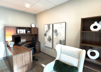 Counselling office at Journey Psychology with desk area, armchair seating, and calming neutral design.